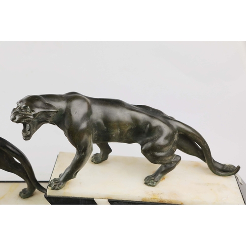 5 - A FRENCH ART DECO LION AND LIONESS SCULPTURE. in spelter on stepped black and white marble base. 85c... 