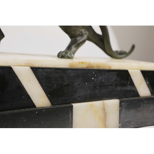 5 - A FRENCH ART DECO LION AND LIONESS SCULPTURE. in spelter on stepped black and white marble base. 85c... 