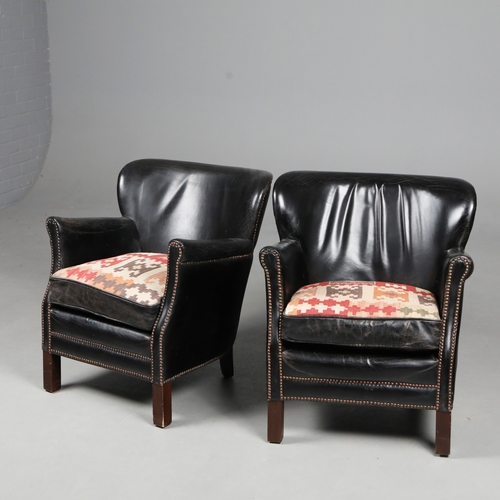 576 - ATTRIBUTED TO ANDREW MARTIN ARMCHAIRS, A PAIR. black leather with reversible kilim seat cushions, 74... 