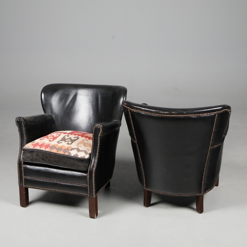576 - ATTRIBUTED TO ANDREW MARTIN ARMCHAIRS, A PAIR. black leather with reversible kilim seat cushions, 74... 