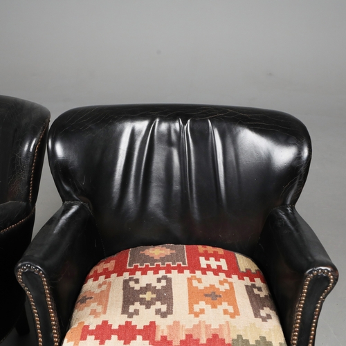 576 - ATTRIBUTED TO ANDREW MARTIN ARMCHAIRS, A PAIR. black leather with reversible kilim seat cushions, 74... 