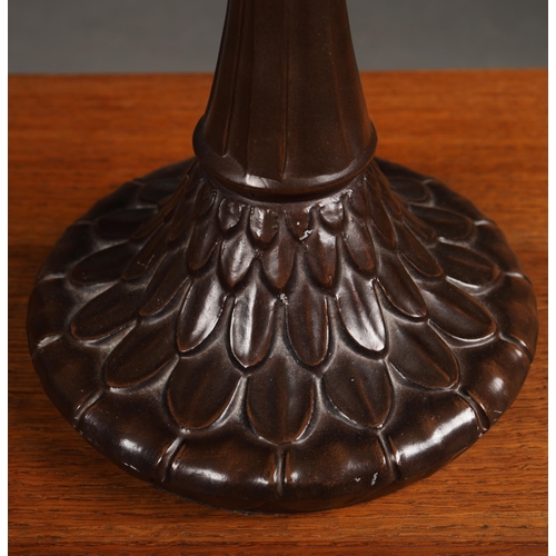 128 - TIFFANY STYLE TABLE LAMP. the shade with a swirling stylised foliage design, bronzed base, raised on... 