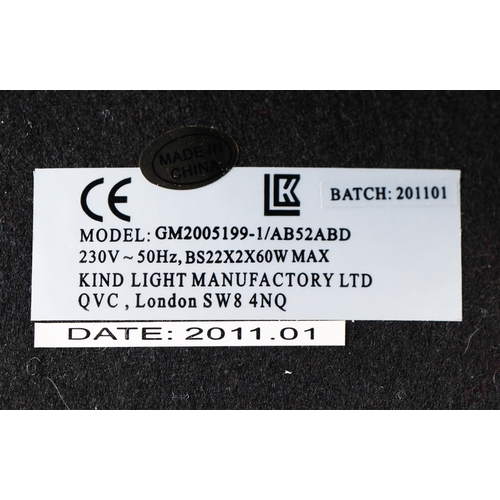 128 - TIFFANY STYLE TABLE LAMP. the shade with a swirling stylised foliage design, bronzed base, raised on... 