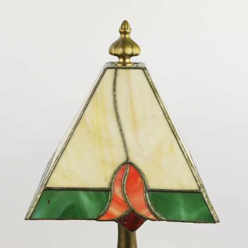 131 - TIFFANY STYLE TABLE LAMP. fitted with a four sided shade in cream and green, raised on a brass lamp ... 
