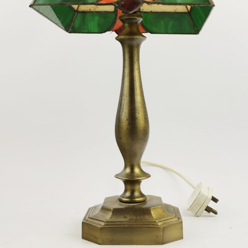 131 - TIFFANY STYLE TABLE LAMP. fitted with a four sided shade in cream and green, raised on a brass lamp ... 
