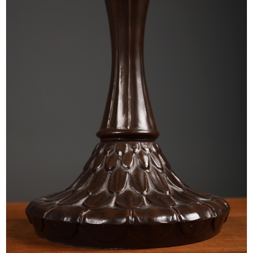 128 - TIFFANY STYLE TABLE LAMP. the shade with a swirling stylised foliage design, bronzed base, raised on... 