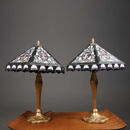 129 - TIFFANY STYLE TABLE LAMPS, A PAIR. each with hexagonal shades with a repeated symmetrical designs, r... 