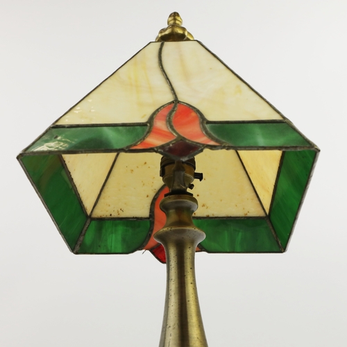 131 - TIFFANY STYLE TABLE LAMP. fitted with a four sided shade in cream and green, raised on a brass lamp ... 