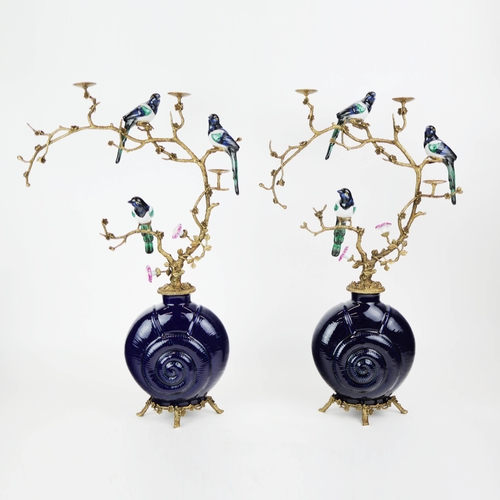 138 - CANDELABRA, A PAIR. in the form of birds amongst trees, shell form bases, ceramic and gilt metal, 65... 