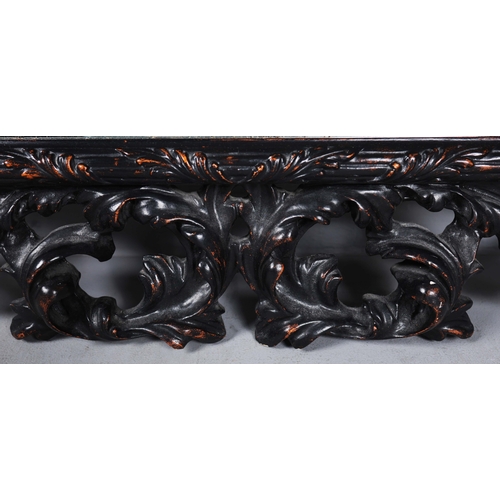 182 - A ROCOCO STYLE BLACK STAINED WALL MIRROR. having an acanthus carved frame, 116cm high, 83cm wide.