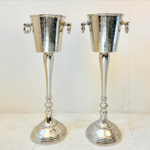 213 - PAIR OF POLISHED METAL CHAMPAGNE BUCKETS ON STANDS WITH HANDLES. 77cm H x 24cm W x 30cm D.