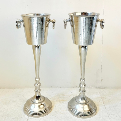 213 - PAIR OF POLISHED METAL CHAMPAGNE BUCKETS ON STANDS WITH HANDLES. 77cm H x 24cm W x 30cm D.