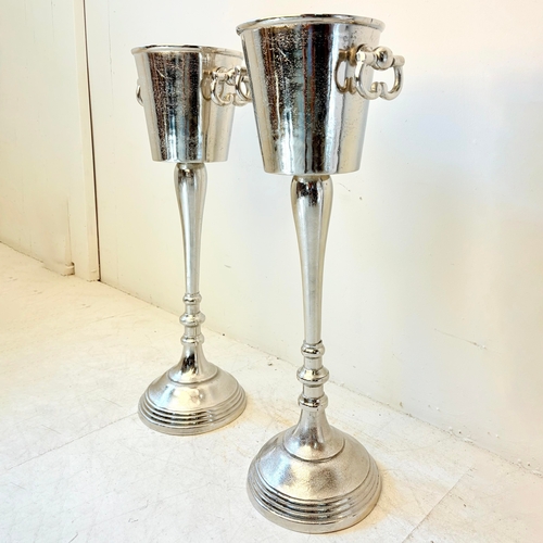 213 - PAIR OF POLISHED METAL CHAMPAGNE BUCKETS ON STANDS WITH HANDLES. 77cm H x 24cm W x 30cm D.