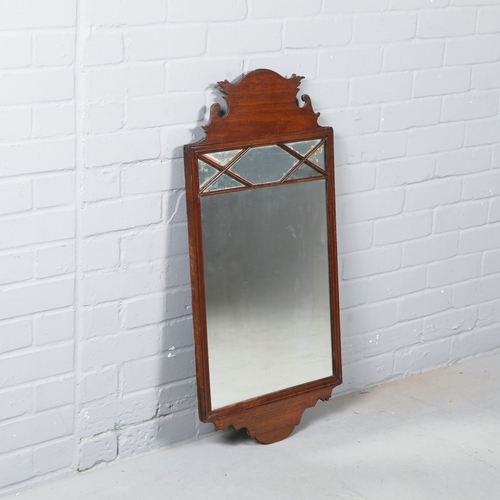 215 - WALL MIRROR. 19th C mahogany with a shaped frame 90cm t x 45 cm w.