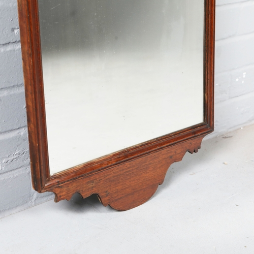 215 - WALL MIRROR. 19th C mahogany with a shaped frame 90cm t x 45 cm w.