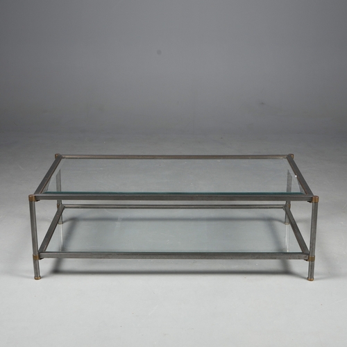 217 - COFFEE TABLE. the bevelled glass top on a metal base with brass trim over an under tier 41 cm t x 12... 