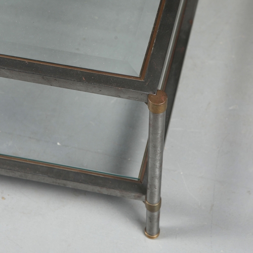 217 - COFFEE TABLE. the bevelled glass top on a metal base with brass trim over an under tier 41 cm t x 12... 