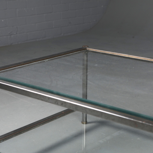 217 - COFFEE TABLE. the bevelled glass top on a metal base with brass trim over an under tier 41 cm t x 12... 
