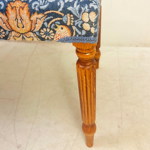 224 - FOOTSTOOL IN WILLIAM MORRIS STYLE UPHOLSTERY ON REEDED SUPPORTS. 45cm H x 100cm W x 38cm D.