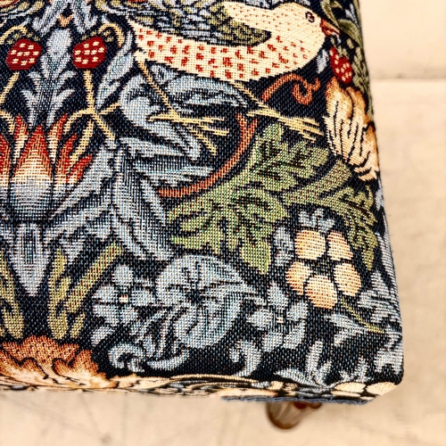 224 - FOOTSTOOL IN WILLIAM MORRIS STYLE UPHOLSTERY ON REEDED SUPPORTS. 45cm H x 100cm W x 38cm D.