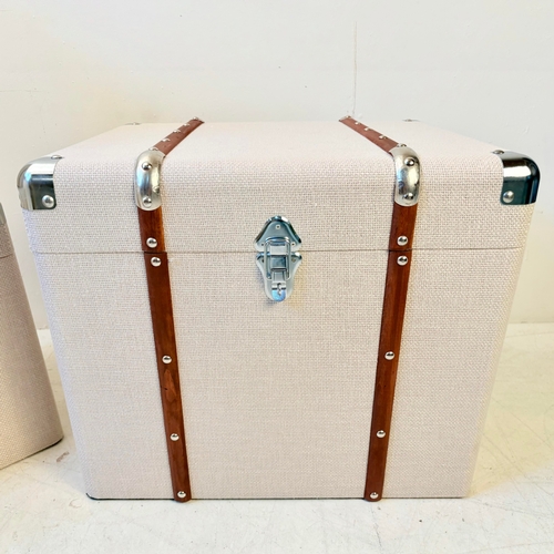 246 - GRADUATED SET OF THREE LUGGAGE STYLE TRUNKS IN LINEN. Largest 50cm H x 50cm W x 50cm D.