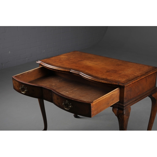 252 - QUEEN ANNE STYLE WALNUT SERPENTINE WRITING TABLE. Early 20th century with drawer and cabriole suppor... 