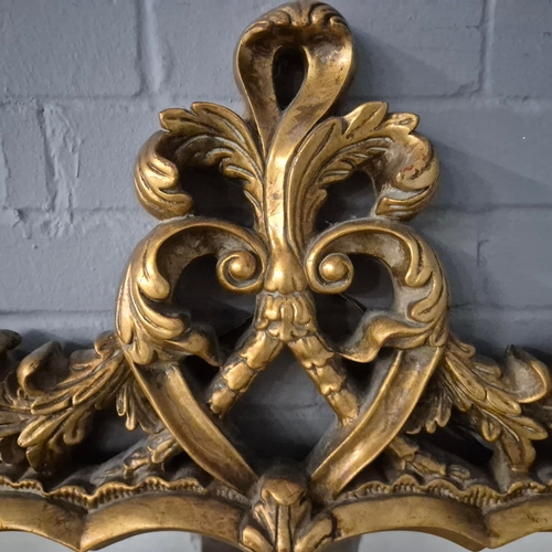 258 - A BAROQUE STYLE RECTANGULAR WALL MIRROR. elaborately moulded and gilded frame, with a large scrollin... 