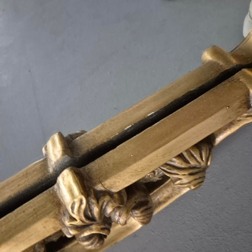 258 - A BAROQUE STYLE RECTANGULAR WALL MIRROR. elaborately moulded and gilded frame, with a large scrollin... 