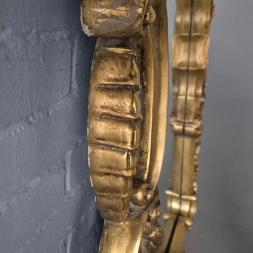 258 - A BAROQUE STYLE RECTANGULAR WALL MIRROR. elaborately moulded and gilded frame, with a large scrollin... 