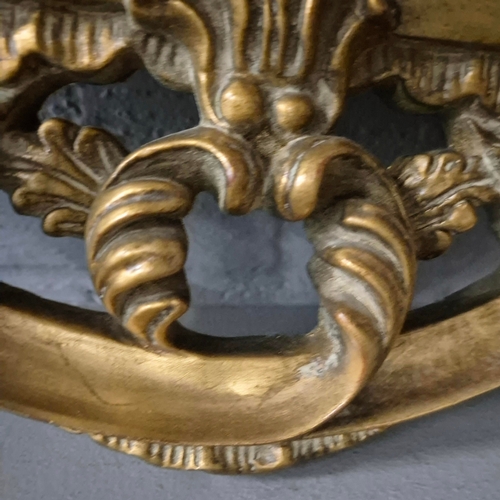 258 - A BAROQUE STYLE RECTANGULAR WALL MIRROR. elaborately moulded and gilded frame, with a large scrollin... 