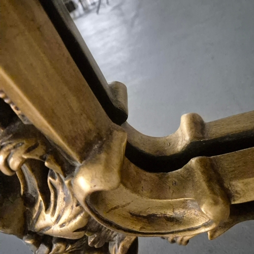 258 - A BAROQUE STYLE RECTANGULAR WALL MIRROR. elaborately moulded and gilded frame, with a large scrollin... 