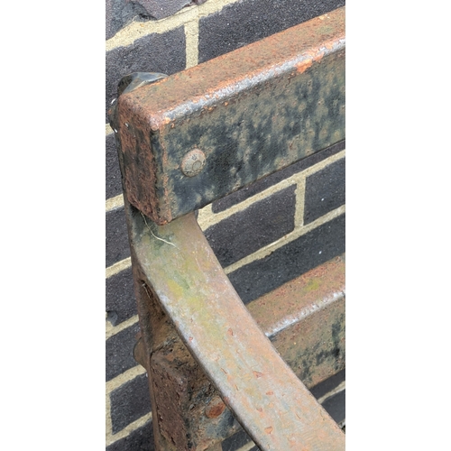 268 - EARLY/MID 20TH CENTURY CAST IRON GARDEN BENCH. 71cm H x 183cm W x 62cm D.