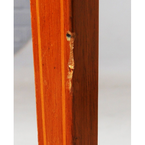 312 - EDWARDIAN MAHOGANY AND INLAID WRITING TABLE. tan leather top above two drawers on brass castors, 75c... 