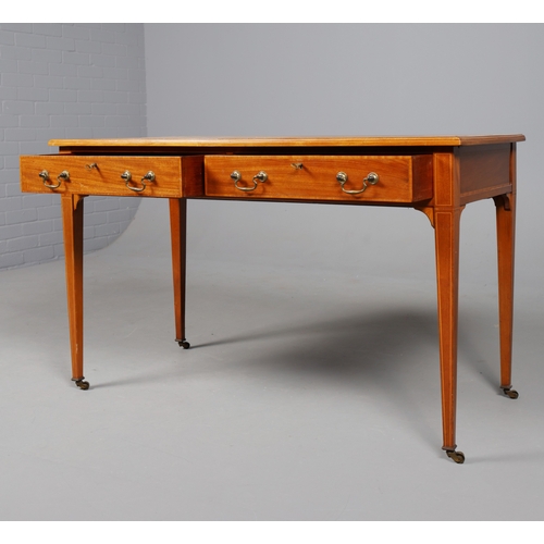 312 - EDWARDIAN MAHOGANY AND INLAID WRITING TABLE. tan leather top above two drawers on brass castors, 75c... 