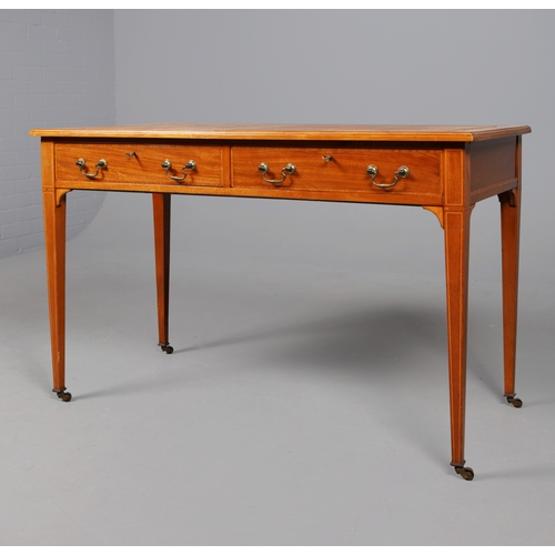 312 - EDWARDIAN MAHOGANY AND INLAID WRITING TABLE. tan leather top above two drawers on brass castors, 75c... 