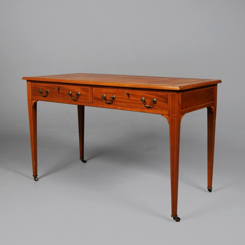 312 - EDWARDIAN MAHOGANY AND INLAID WRITING TABLE. tan leather top above two drawers on brass castors, 75c... 
