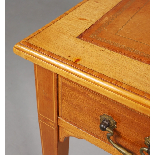 312 - EDWARDIAN MAHOGANY AND INLAID WRITING TABLE. tan leather top above two drawers on brass castors, 75c... 