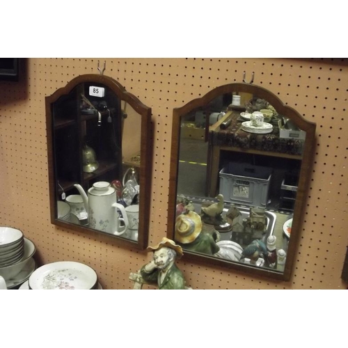 85 - Pair of walnut framed arched wall mirrors, 17 in. x 12 in.