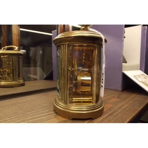 104 - Gilded brass cased carriage clock of oval form, Matthew Norman, eight day movement.