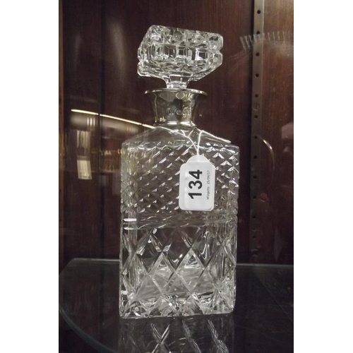134 - Square cut glass decanter with silver collar, 9.5 in. high.