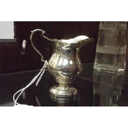 140 - Silver cream jug with shaped loop handle, 3.5 in. high, 2.2 ozs.