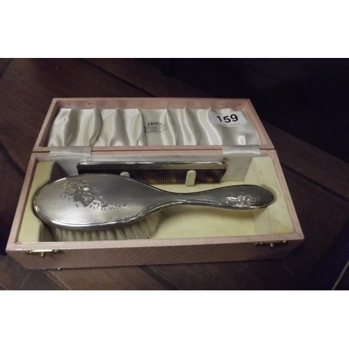 159 - Child's silver backed hairbrush and comb, in fitted box.