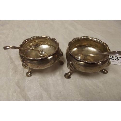 237 - Pair of circular silver open salts with shaped rims, on hoof feet, 2.5 in. diameter, with two silver... 