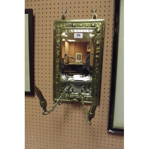 96 - Rectangular embossed brass framed wall mirror with twin candle sconce.