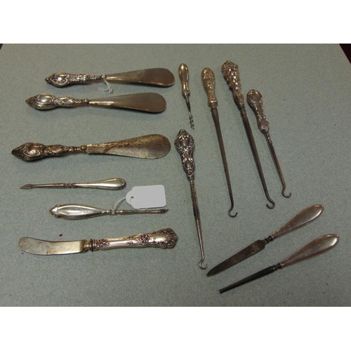 238 - Various silver handled button hooks, shoe horns, etc.