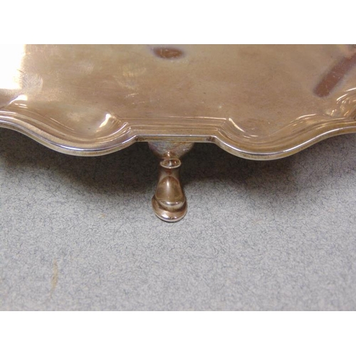 3 - Circular silver card tray with shaped moulded border, standing on three hoof feet, 8.25 in. diameter... 