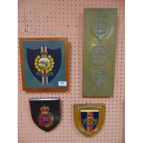 87 - Brass railways plaque, and three painted wood shields, Hong Kong.