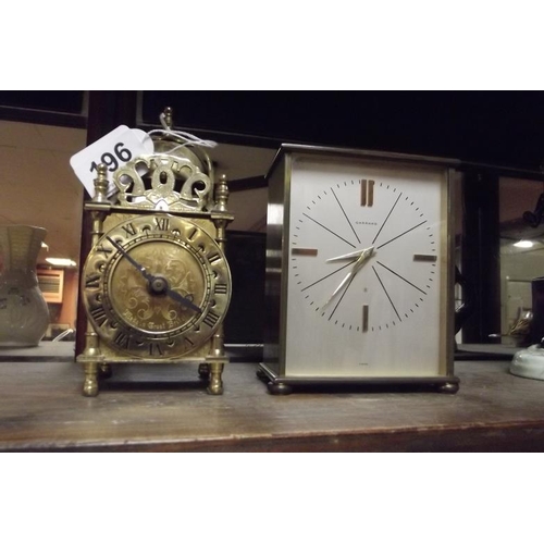 196 - Brass lantern clock, together with a Garrard 8-day clock. (2)