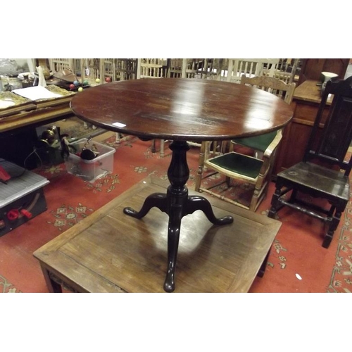 306 - Mahogany tripod table, circular top on baluster turned column and downswept supports, 28 in. high.