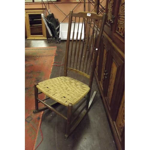 328 - Beech framed spindle-backed basket weave rocking chair.